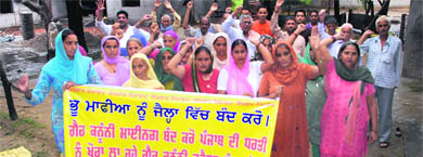 Villagers during a protest against plying of trucks carrying sand and gravel on their village's link road in Chakk-Meerpur, Hoshiarpur. 