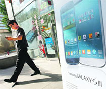 A man leaves a store selling Samsung Galaxy smartphones in Seoul. Samsung Electronics shares tumbled over 7% on Monday, wiping $12 billion off the South Korean giant's market value, as Apple Inc's sweeping legal victory in their US patent battle raised concerns about its smartphones business  its biggest cash cow. 