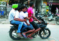 Throwing traffic rules to the wind, five young boys ride a bike near Hanuman Chowk in Bathinda on Monday. The politically-active city is no stranger to such violations. 