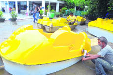 Workers repair boats at the Sukhna Lake in Chandigarh. 