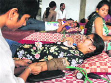 A student donates blood during a camp organised at the Post Graduate Government College for Girls, Sector 42, in Chandigarh on Monday. 