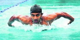 Karan Brar of DAV on his way to make a new record at the PU Inter-college Swimming Competition in Chandigarh on Monday.