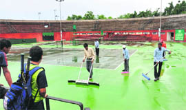 CLTA staff cleans the centre court ahead of the Davis Cup match in Chandigarh on Monday. 