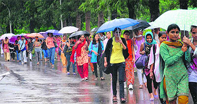 College girls enjoy rain after classes at GCG in Sector 11, Chandigarh, on Monday. 