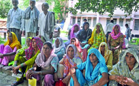 BPL card holders outside the food supply office at ITO, waiting for their ration in New Delhi on Monday.