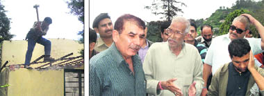 A Landour Cantt Board official demolishes an illegal construction at Lakshmanpuri in Mussoorie; and (right) residents of the area haggle with CEO of the cantt board Ashok Kumar (extreme left ) during the demolition exercise.