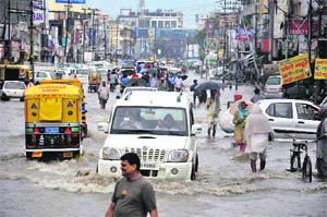Traffic wades through a flooded road in Karnal on Monday.
