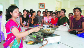 Puja Bansal teaching culinary techniques to girls in MHD College for Women at Odhan in Sirsa.