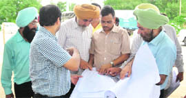 RG Sharma (second from right), Assistant General Manager of the Delhi Metro Rail Corporation, discusses the Metro rail plan with officials at Ayali Chowk in Ludhiana on Monday.