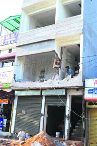 The illegal structure that was pulled down by the MC in the Model Gram locality in Ludhiana on Monday.