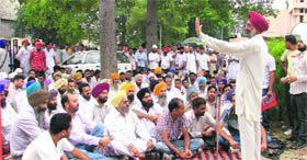 Members of the Earth Moving Association hold a protest in Ludhiana on Monday.
