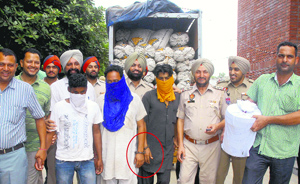 Police officials along with handcuffed drug smugglers in Jalandhar.