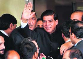 Pakistan Prime Minister Raja Pervez Ashraf waves upon his arrival at the Supreme Court in Islamabad on Monday