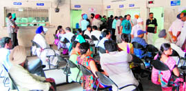 Applicants for the registration of property wait for their turns at the tehsil complex in Amritsar on Tuesday.