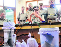 Inspector-General, Border Range, RP Mittal shows the recovered material from two robbers