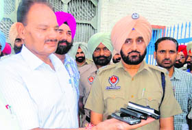 A police team shows the mobile phones recovered from the central jail in Amritsar on Tuesday.