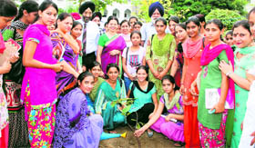 Students of the Khalsa College for Women plant a sapling on the college premises in Amritsar on Tuesday.