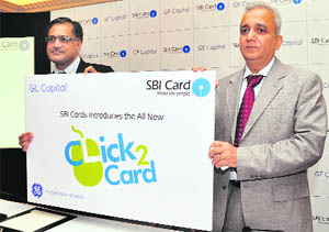 Sanjeev Jain,CEO,GE Capital Business Process Management Services (L) with SBI Cards & Payment Services CEO Kadambai Narahari at the launch of Click2Card, a customer-friendly online credit card application service at a press conference in New Delhi on Tuesday.