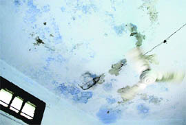 The damp roof of Maternity and Child Health Centre at Central Town in Jalandhar; and (below) housed in two rooms, the dispensary cramps for space.