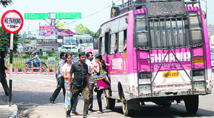 A minibus stops in the middle of a road in Jammu on Tuesday. 