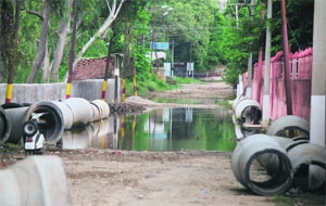 A waterlogged damaged canal road in Jammu