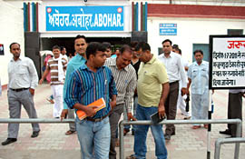 Senior railway engineers cross the obstacles fixed at Abohar railway station to check the smooth flow of commuters.
