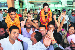 Indian cricketers Prashant Chopra (right) and Sandeep Sharma, winners of the under-19 cricket World Cup 2012, welcomed by fans on their arrival at the Chandigarh Airport on Wednesday.