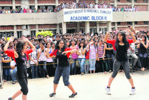 Students present a dance performance during a cultural function; and (below) policemen interrupt the function midway at the University Institute of Engineering and Technology at Panjab University in Chandigarh on Wednesday. 