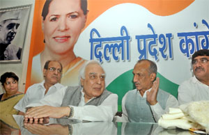 Human Resource Development Minister Kapil Sibal with DPCC president JP Aggarwal and other leaders holds a meeting in New Delhi on Wednesday. 