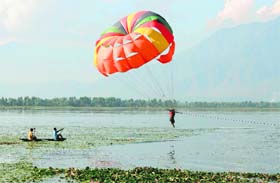 A girl paraglides above the Dal Lake in Srinagar