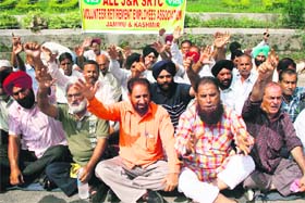 Members of the All J&K SRTC Volunteer Retirement Employees Association stage a protest in support of their demands in Jammu on Wednesday