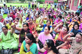 Teachers hold a protest at Malwa Khalsa Senior Secondary School in Ludhiana on Wednesday