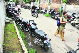 Vehicles parked by GGN Khalsa College students in a residential area near Sham Singh Road in Ludhiana
