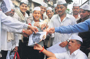Mumbai dabbawallahs burn a poster of Ajmal Kasab as they celebrate the SC verdict on him in Mumbai.