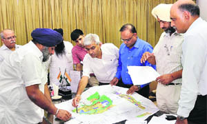Punjab Deputy Chief Minister Sukhbir Singh Badal reviews the extension plan of Mullanpur at a meeting in Mohali on Wednesday. 