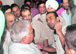 Punjab Health Minister Madan Mohan Mittal argues with mediapersons at Rajpura on Wednesday. 