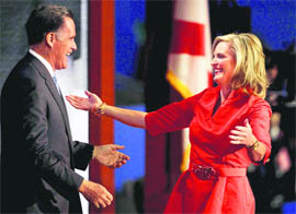 Ann Romney reaches out to hug her husband, Republican presidential nominee Mitt Romney, after she addressed the Republican National Convention in Tampa.