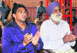 Boxer Manoj Kumar (left) and coach GS Sandhu during the prize distribution ceremony of a boxing tournament at SDPublic School, Sector 32, Chandigarh on Thursday