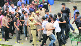 The PU security staff and the Chandigarh Police try to stop rival student party members during a scuffle at the University Institute of Engineering and Technology on Thursday. 
