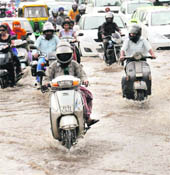 Vehicles wade through the flooded Madhya Marg in Chandigarh on Thursday. 