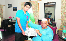 Aman Rehman, a young animator, shows his work to Governor Aziz Qureshi in Dehradun on Thursday. 