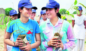 Girls are all smiles during plantation of saplings in the Mata Harki Devi College for Women at Odhan in Sirsa.