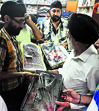 Shopkeepers show blood-stained shirt pieces at the Akalgarh market in Ludhiana on Thursday.