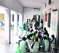 Students attend to a class in an open corridor at Shaheed Sukhdev Thapar Senior Secondary School, Bharat Nagar, in Ludhiana