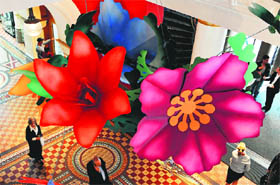 A floral installation crafted by paper engineer Benja Harney hangs from the central dome of Sydney's Queen Victoria Building on Thursday.