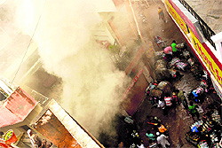 Smoke coming out of an illegal godown which was destroyed in a fire at Burail village in Chandigarh on Friday