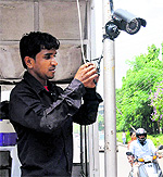 In the wake of the student council elections, a worker installs a high resolution closed-circuit television camera at an entry gate of Panjab University in Chandigarh on Friday