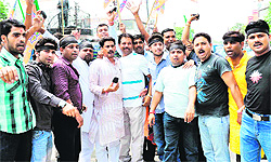 BJP activists stage a protest against the coal scam at Arya Nagar Chowk in Haridwar on Friday