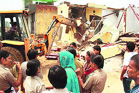A demolition drive in progress to remove illegal constructions in Sector 10 of Gurgaon on Friday. 