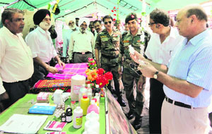 Army officials and ex-servicemen at a stall in Talwara on Friday. A